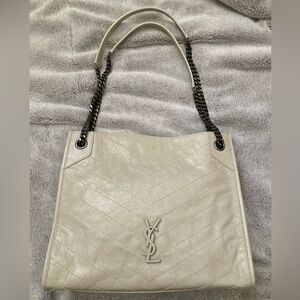 Saint Laurent handbag. It is a vintage beige in like new condition.